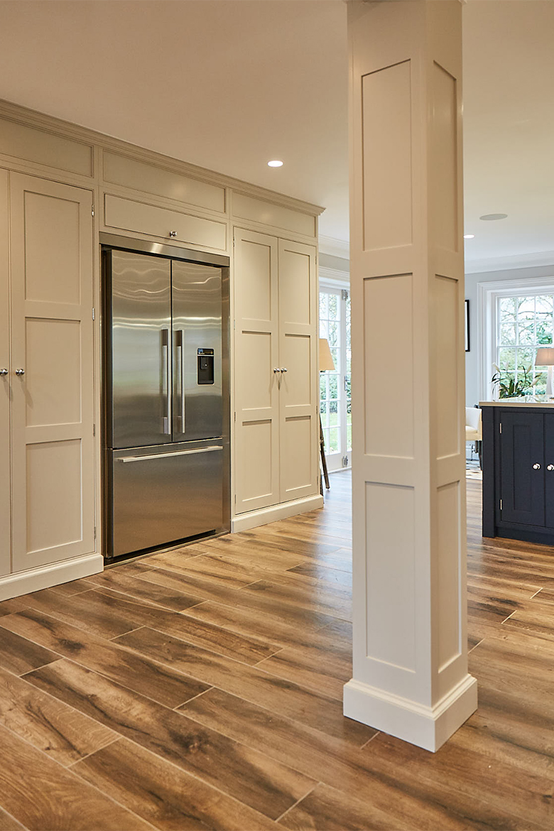 Tall painted cabinets with integrated Fisher & Paykel stainless steel fridge freezer