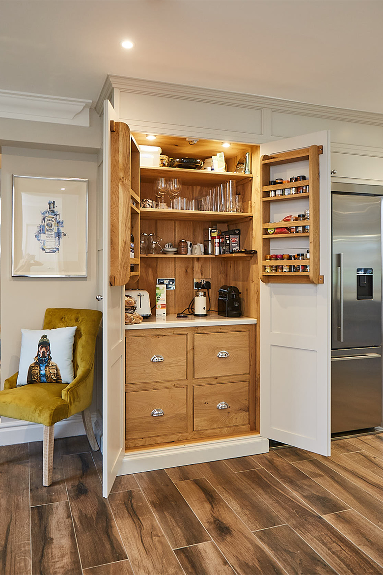 Tall larder unit open with solid oak internals including 4 drawers with quartz worktop and racks on each door