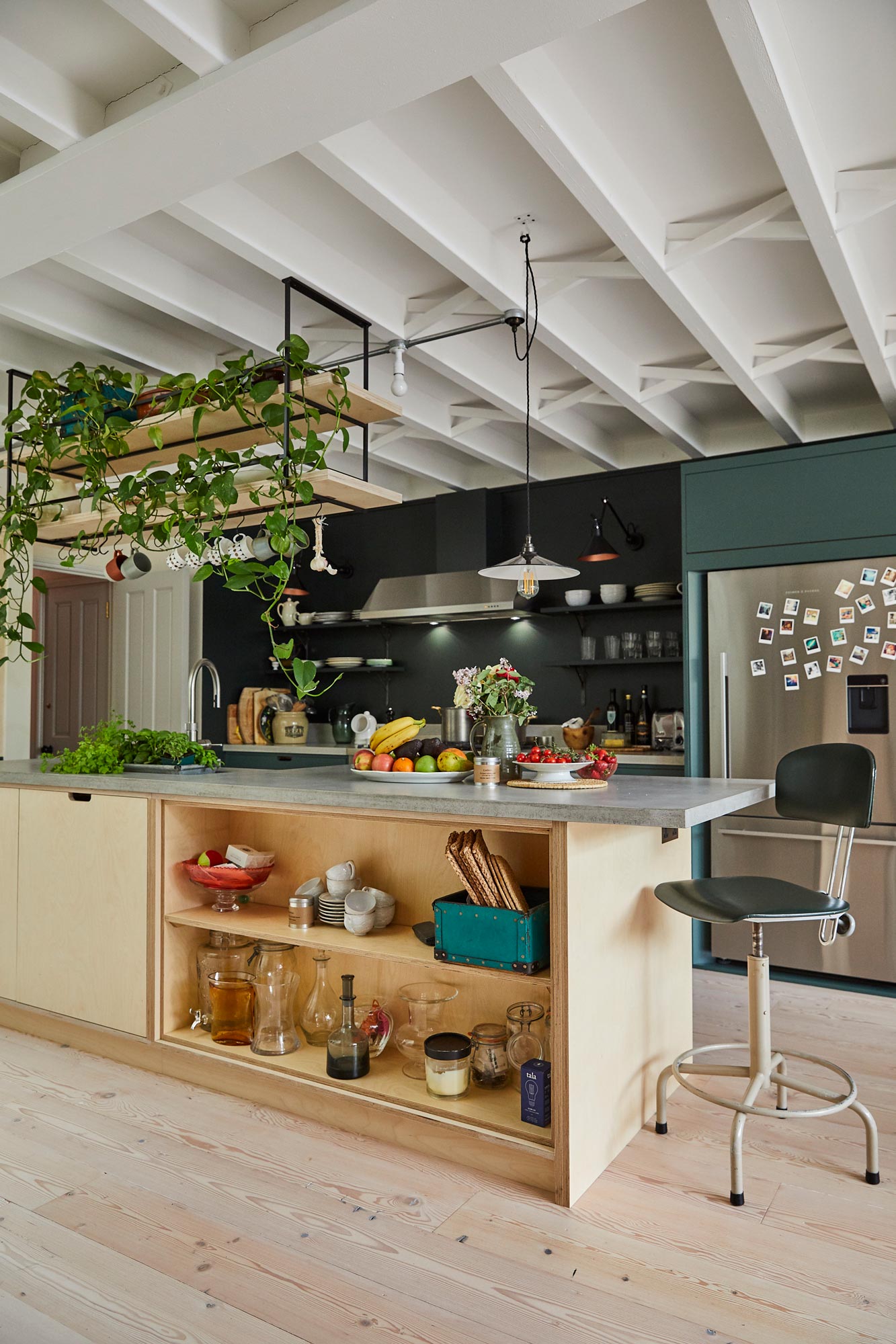 Open birch plywood kitchen unit with bowls and chopping boards stored