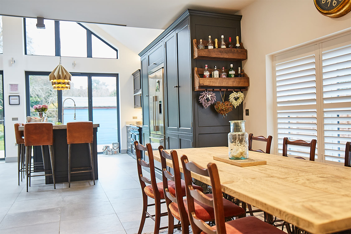 Reclaimed wooden kitchen table with vintage dark wooden chairs