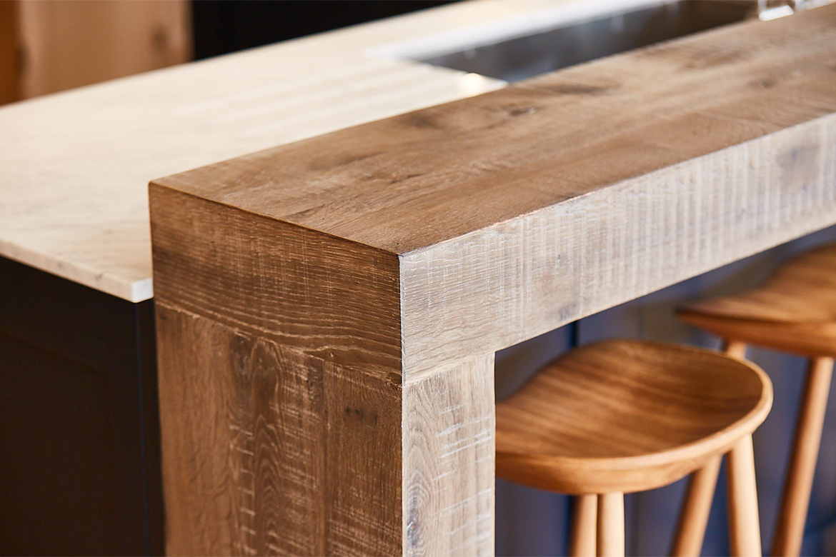 Rustic wood breakfast bar with solid oak bar stools and blue back panel