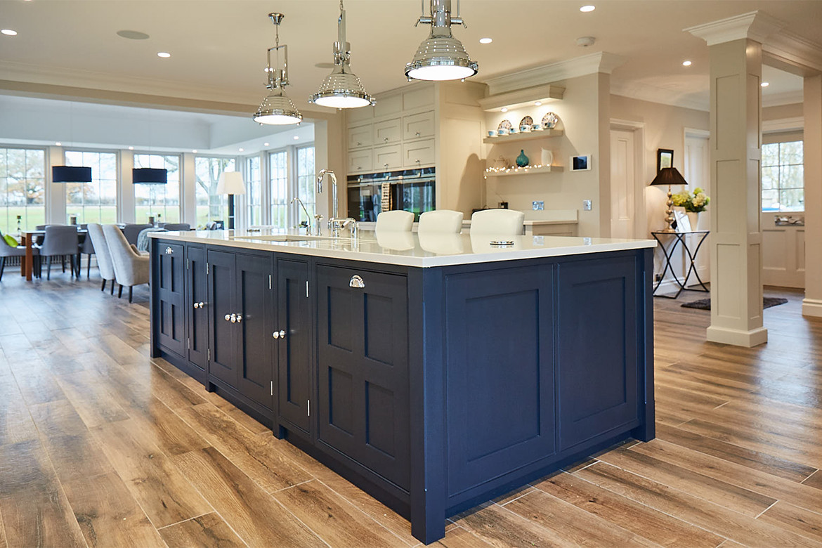 Georgian four panel shaker cabinet doors on island painted Little Greene blue with chrome cup handles