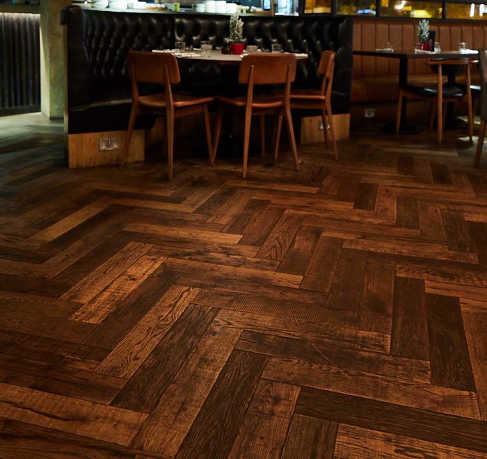 Dining table sits on parquet wood floor