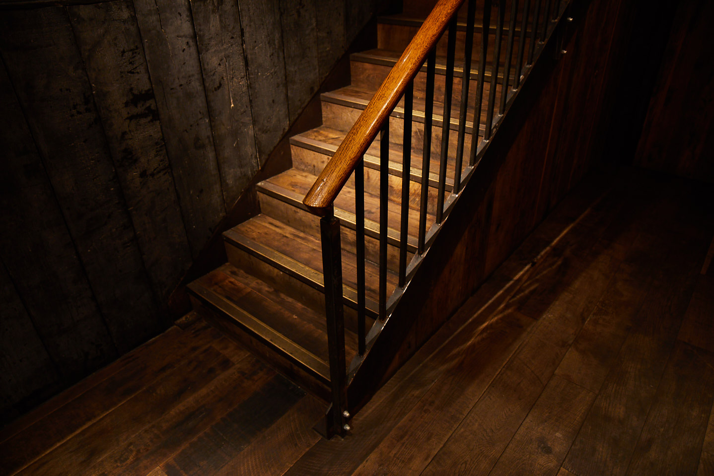 Rustic staircase with raw steel capping and oak handrail