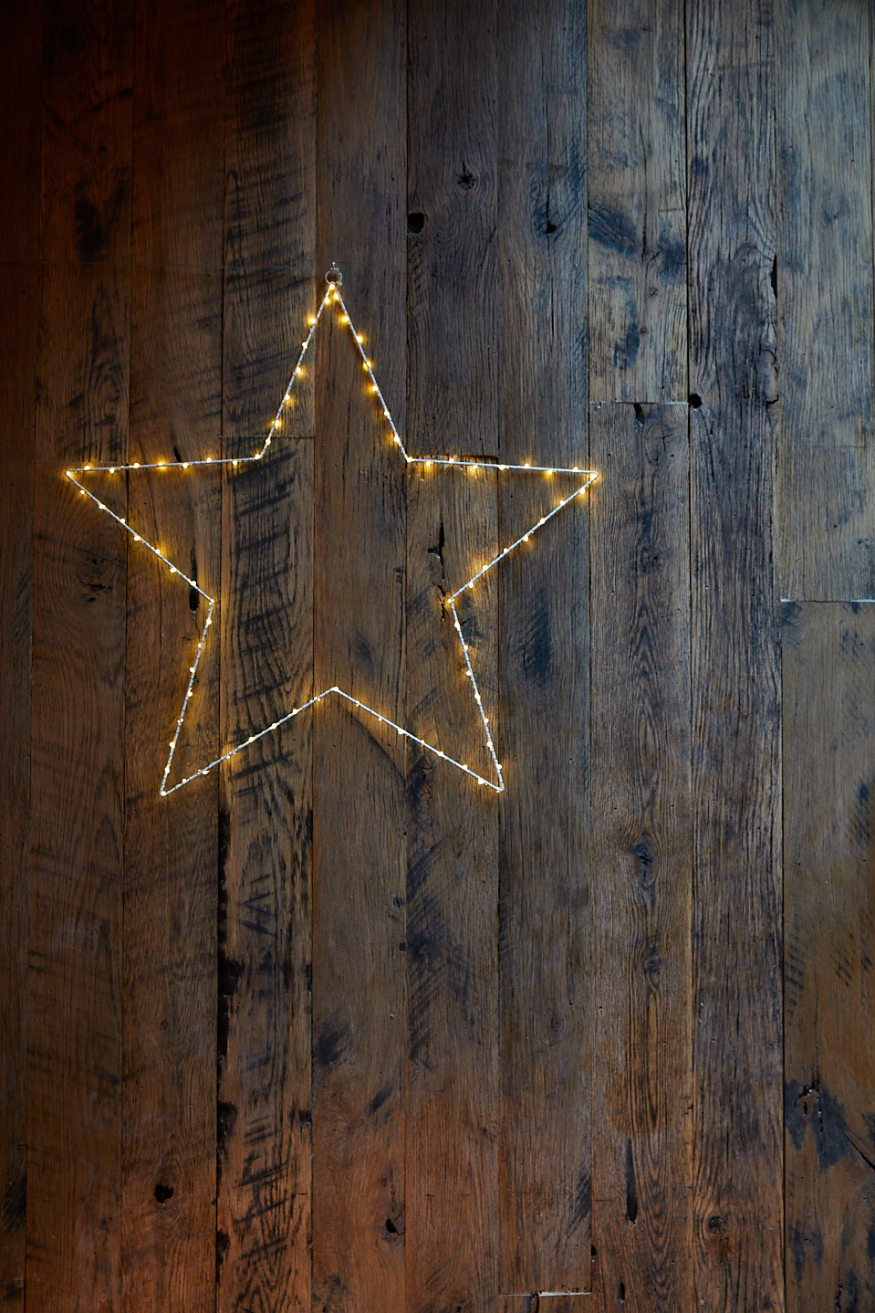 Fairy light star against rustic reclaimed wood wall