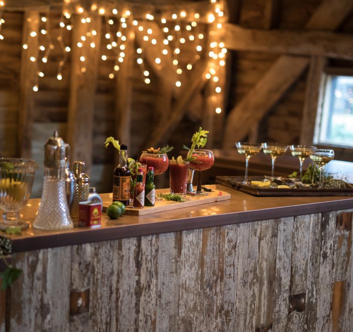 Reclaimed bar with fruit and cocktail shakers sat on copper worktop