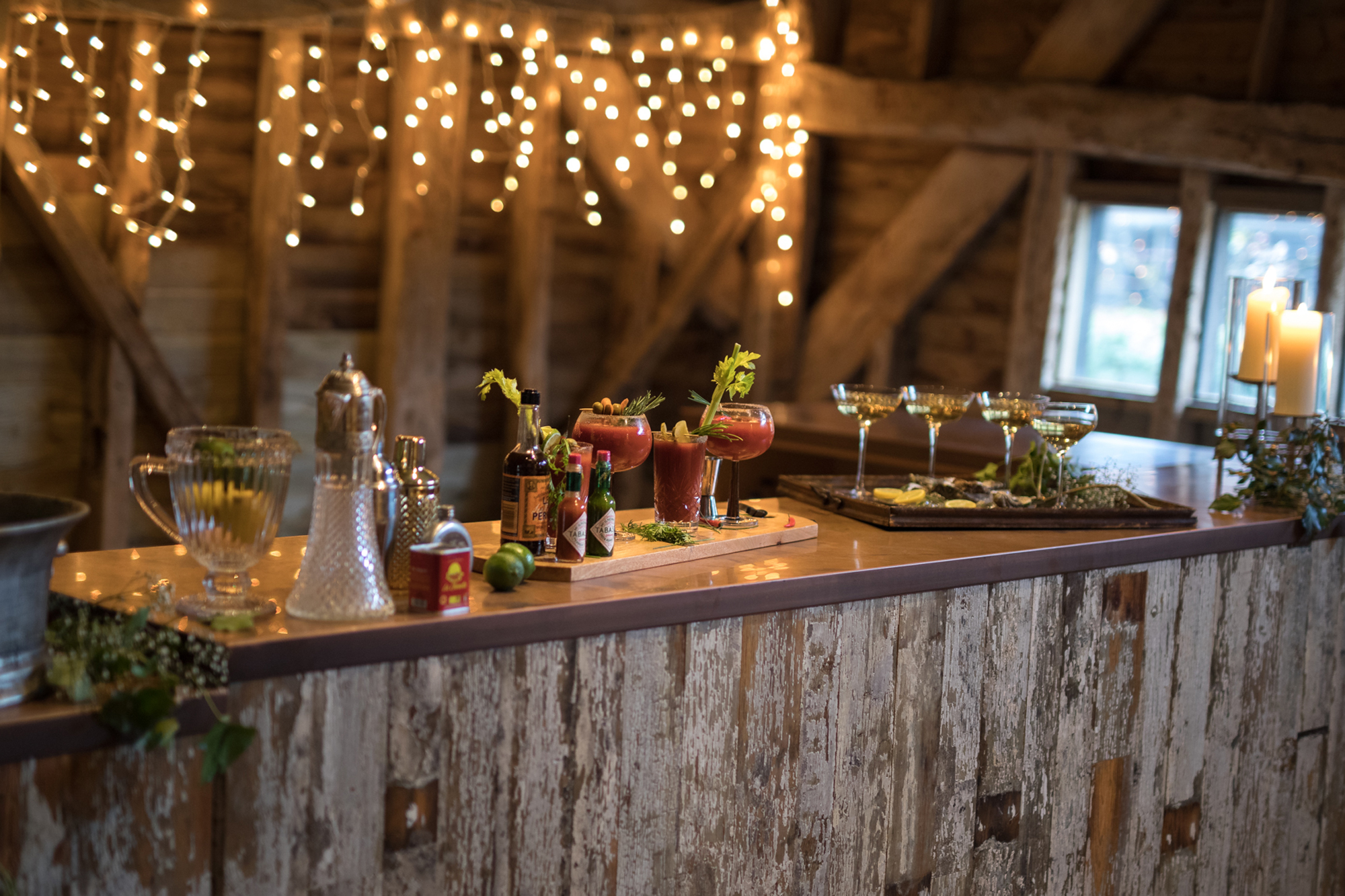 Reclaimed bar with fruit and cocktail shakers sat on copper worktop