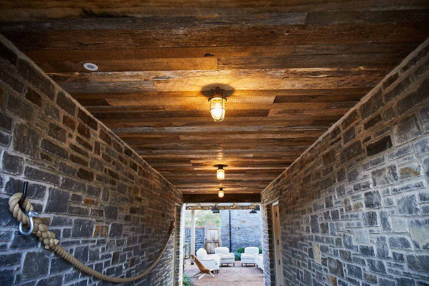 Reclaimed oak cladding used for ceiling in external corridor