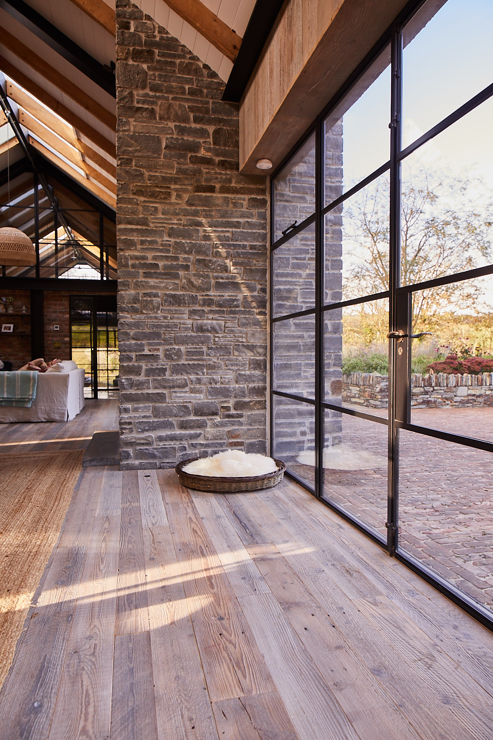 Crittall glass wall with reclaimed oak flooring