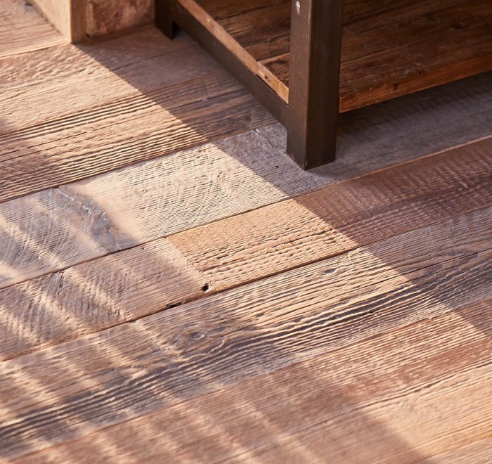 Shadows cast across reclaimed flooring