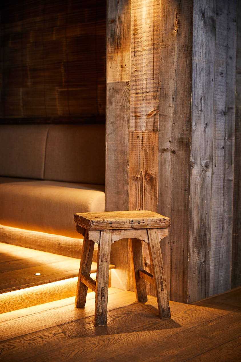 Stool made from reclaimed oak with rustic oak backdrop