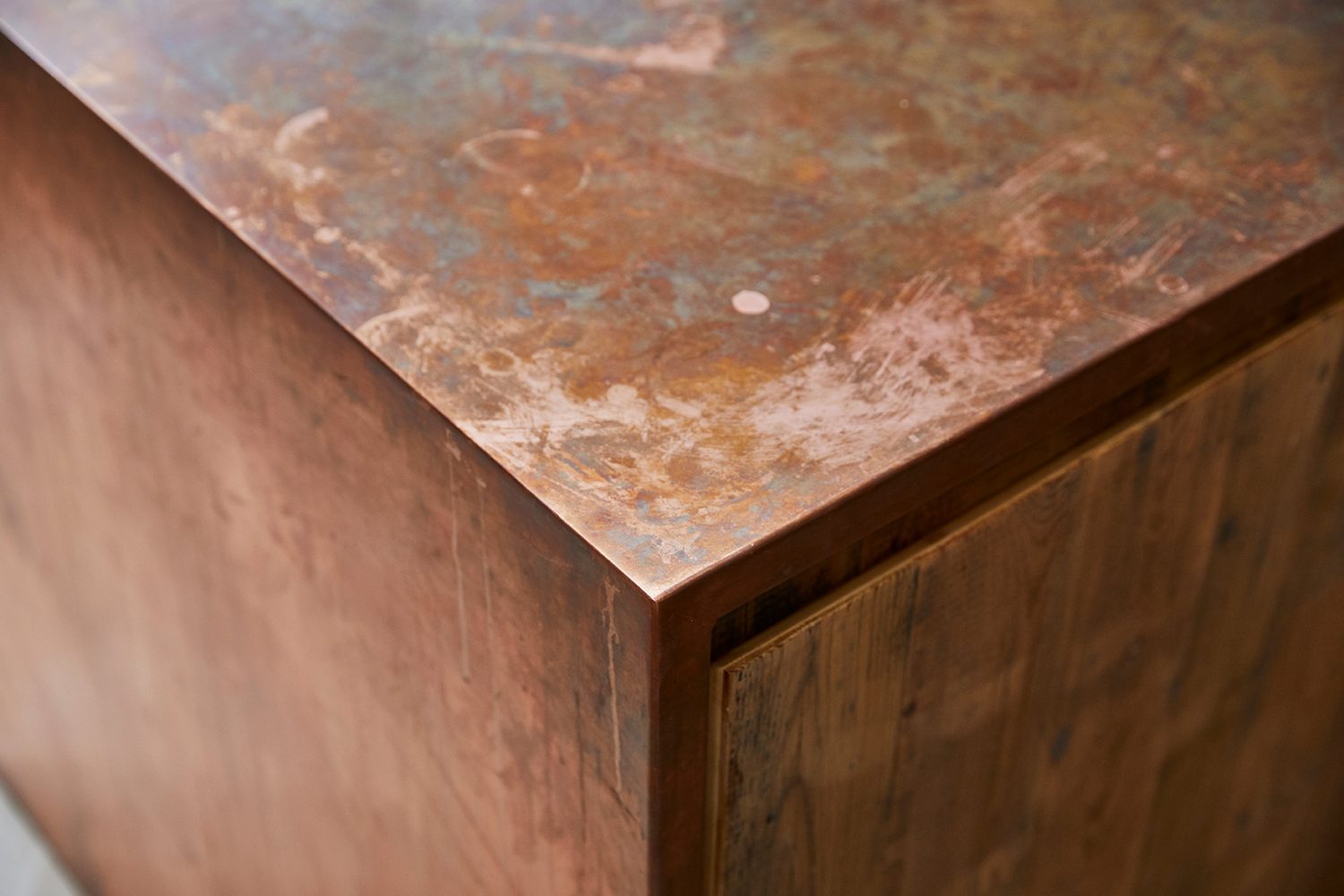 Raw copper worktop with pine door