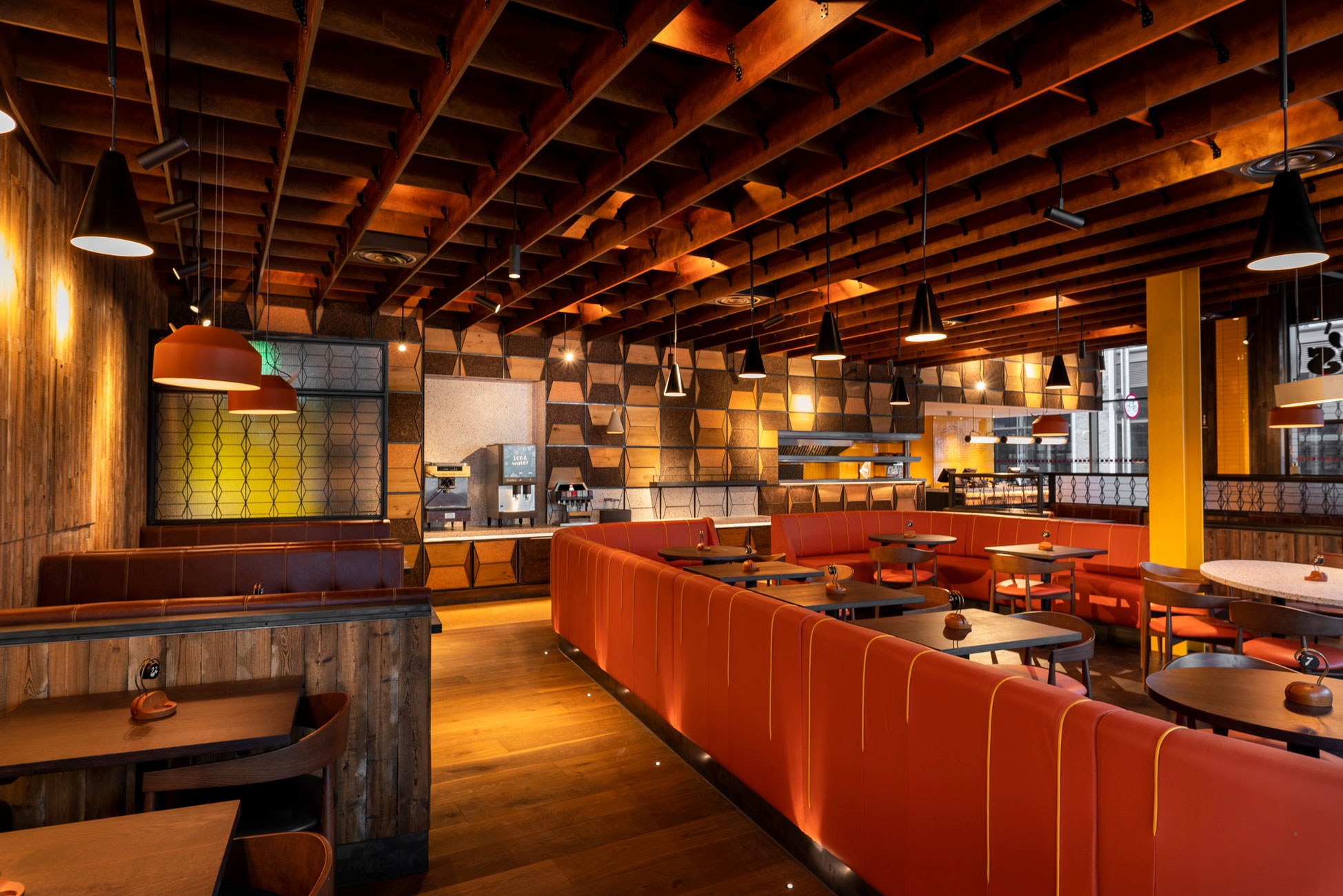 Nando's eatery interior with leather booths and wood cladding