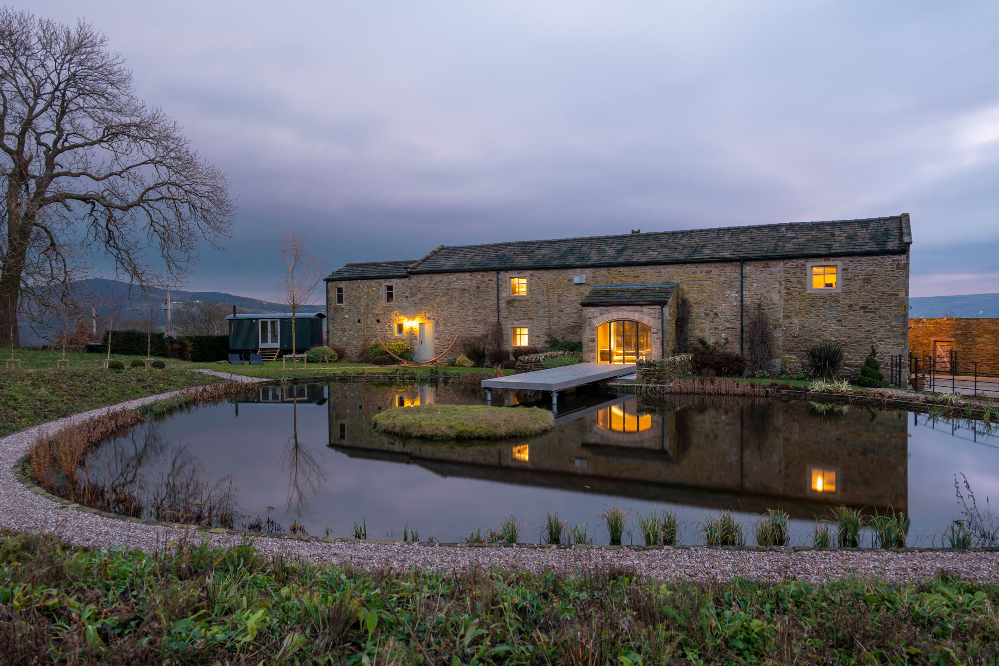 Stone farmhouse building with moat around