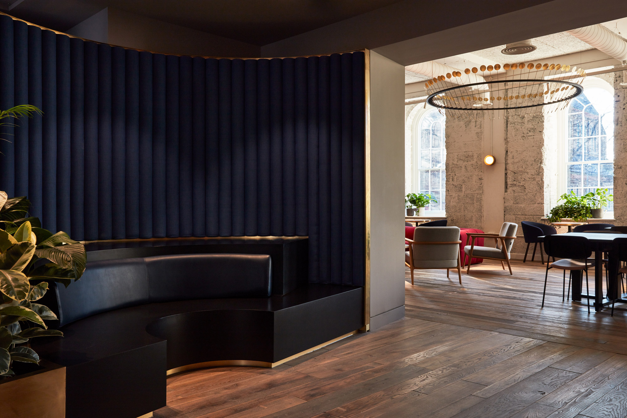 Black leather booth with blue headboard and engineered oak floorboards