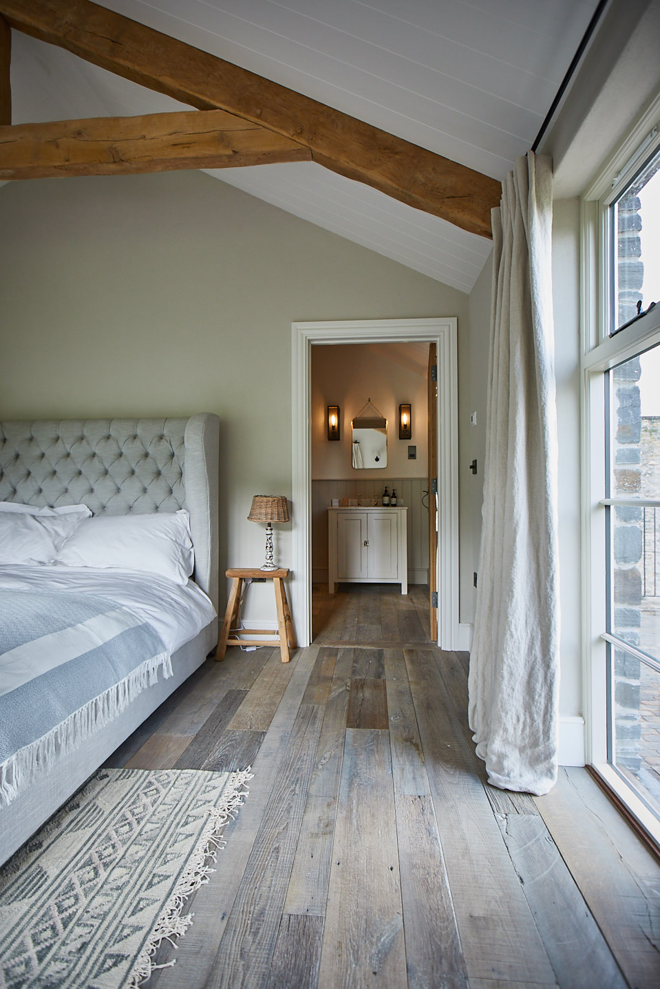 Reclaimed barn oak leading to en suit bathroom