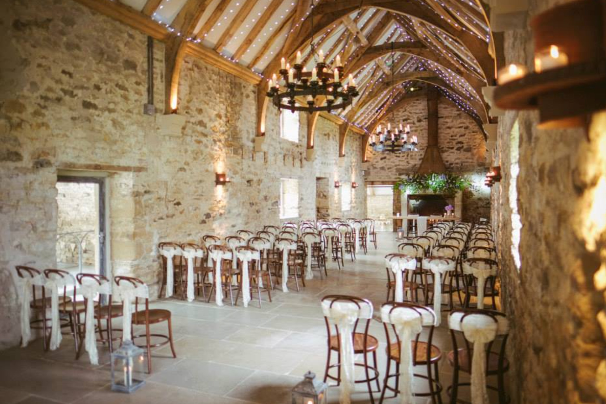 Church set for wedding with bows around pine chairs