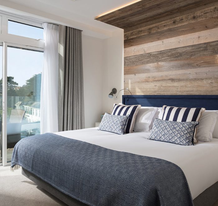 Reclaimed rustic cladding on headboard overlooking scenic view