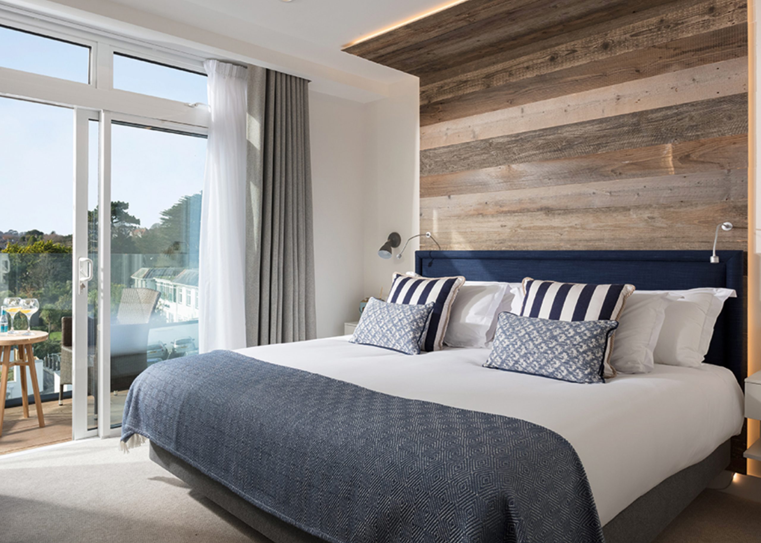 Reclaimed rustic cladding on headboard overlooking scenic view