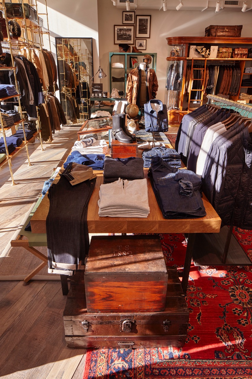 Folded polo shirts on table with vintage interior