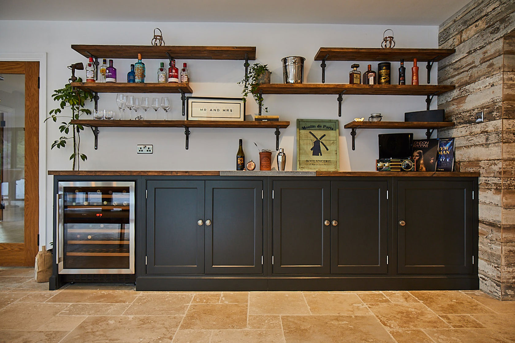 Painted blue units with integrated wine cooler and open rustic shelves