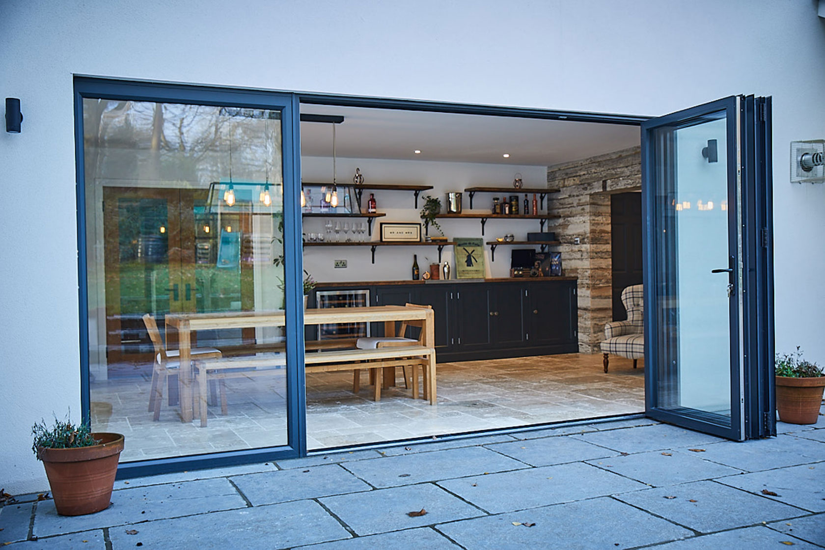 Glass bay windows looking in to dining room with oak table and chairs