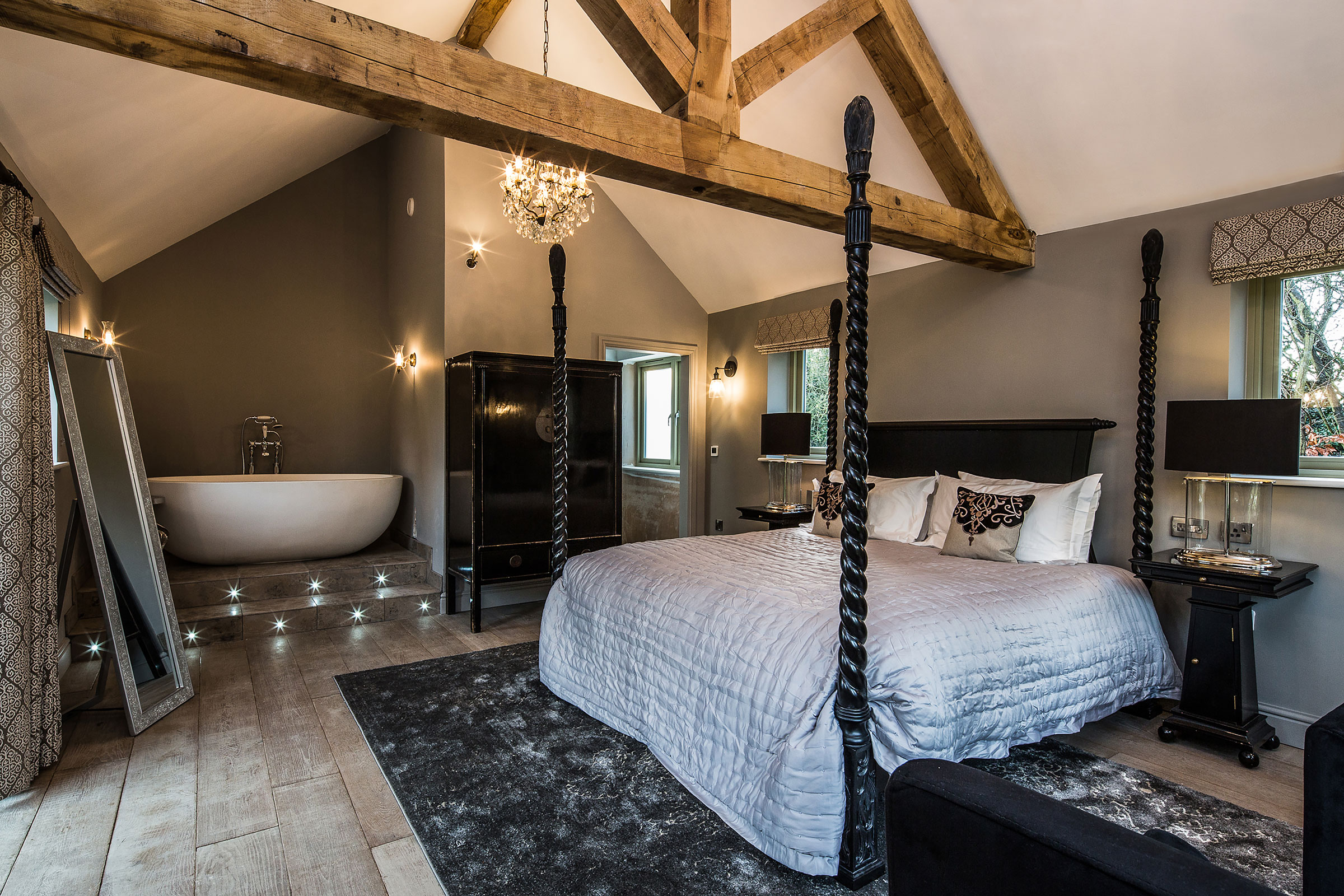 Bedroom with exposed reclaimed beams