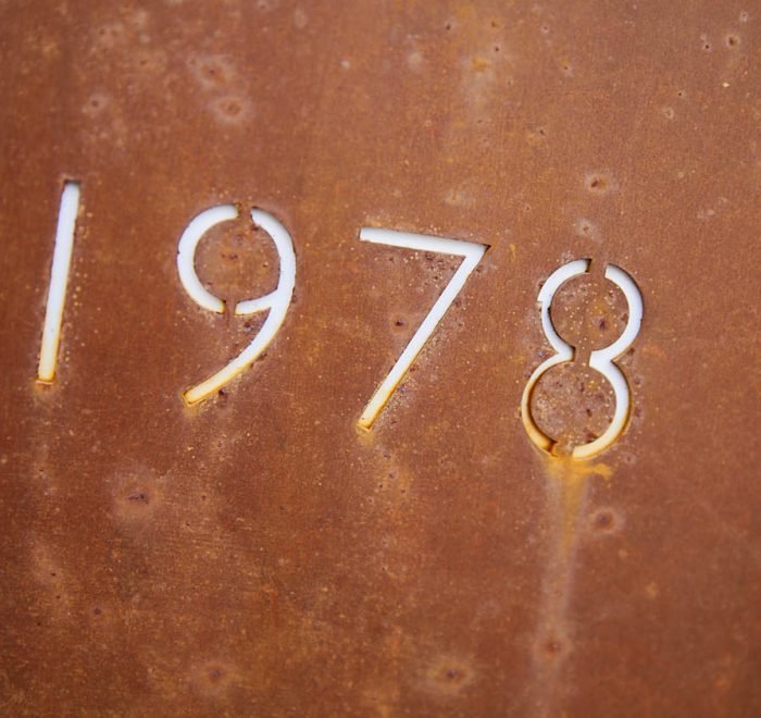 Rusted metal sign with 1978 year cut out