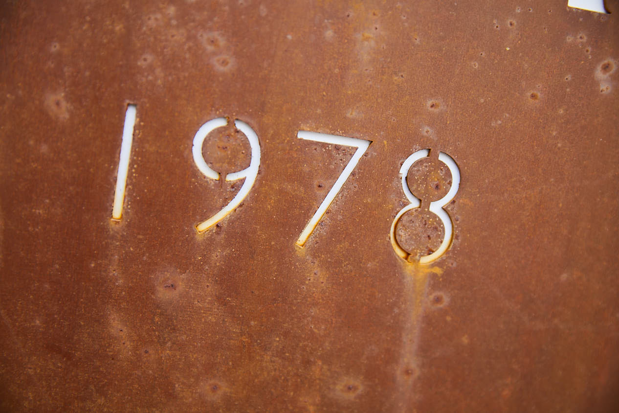 Rusted metal sign with 1978 year cut out