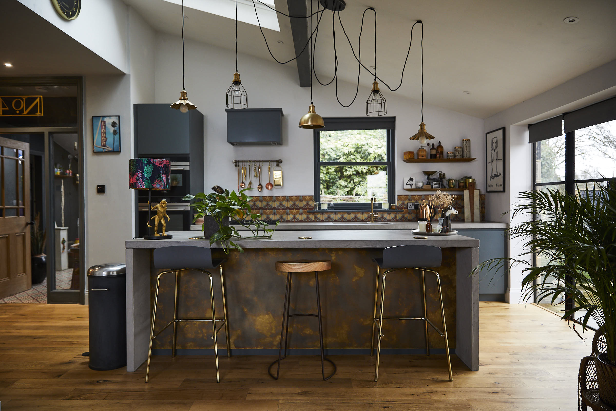 Antique brass and concrete bespoke kitchen island with bar stools