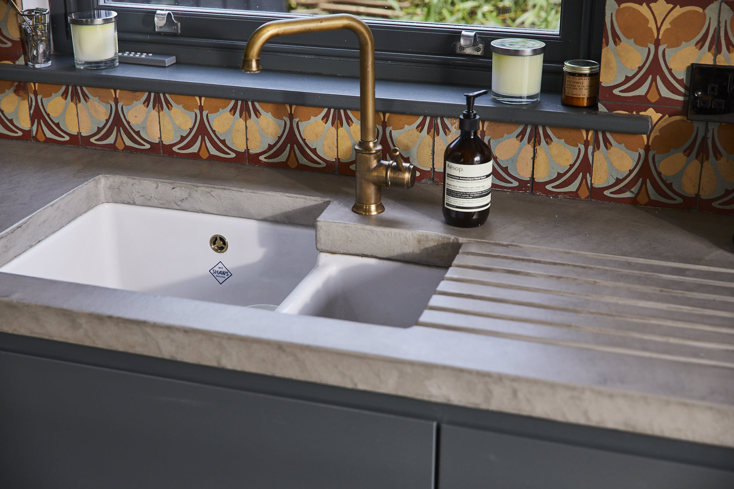 Ceramic white kitchen sink integrated in to solid concrete kitchen worktops