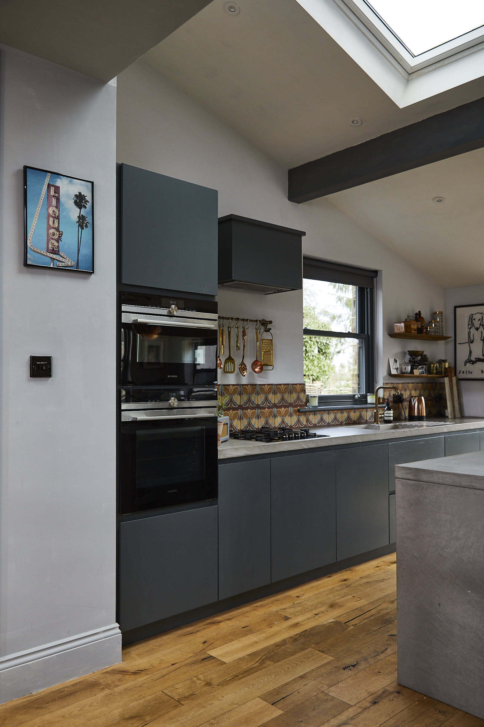 Integrated Siemens eye level ovens in slab painted tall kitchen units