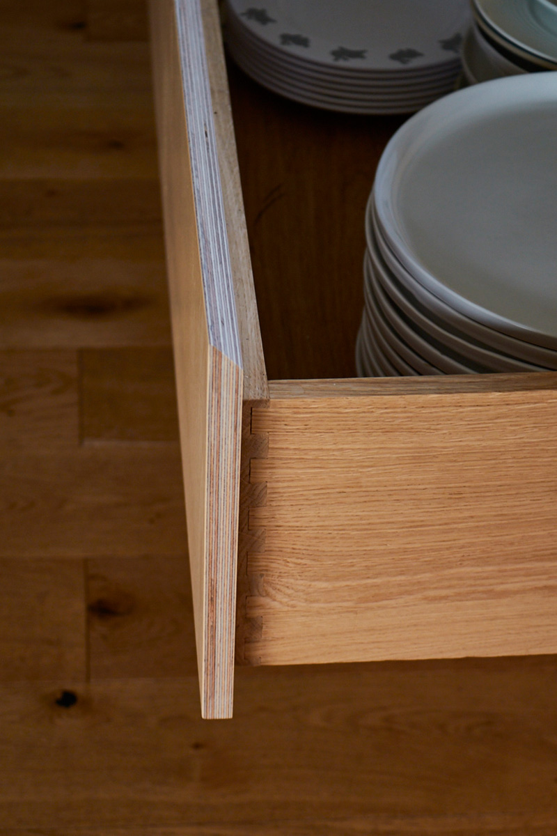 Solid oak drawer box with stack of ceramic plates