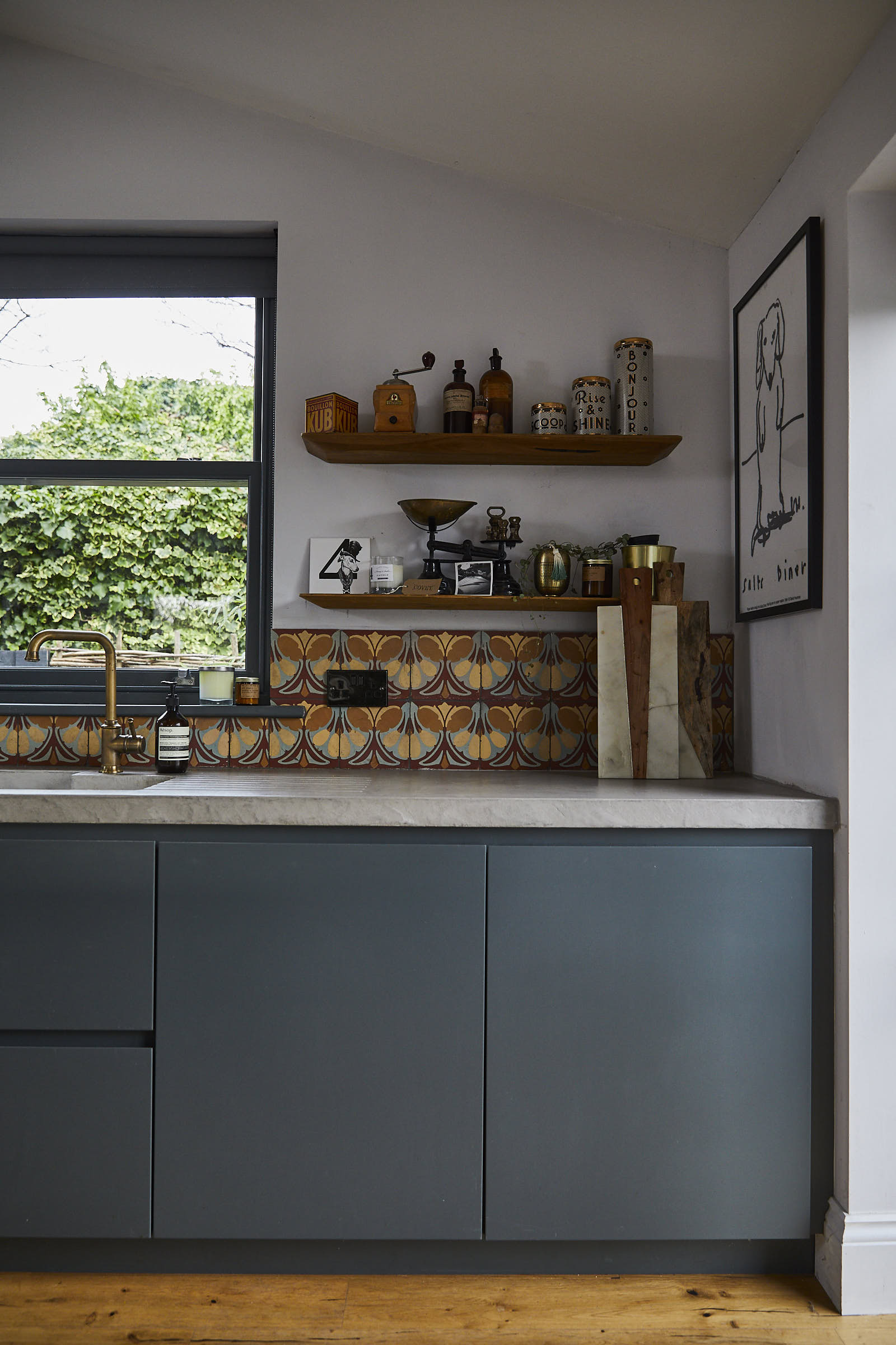 Painted Little Greene slab double door kitchen units with concrete worktops and open shelves
