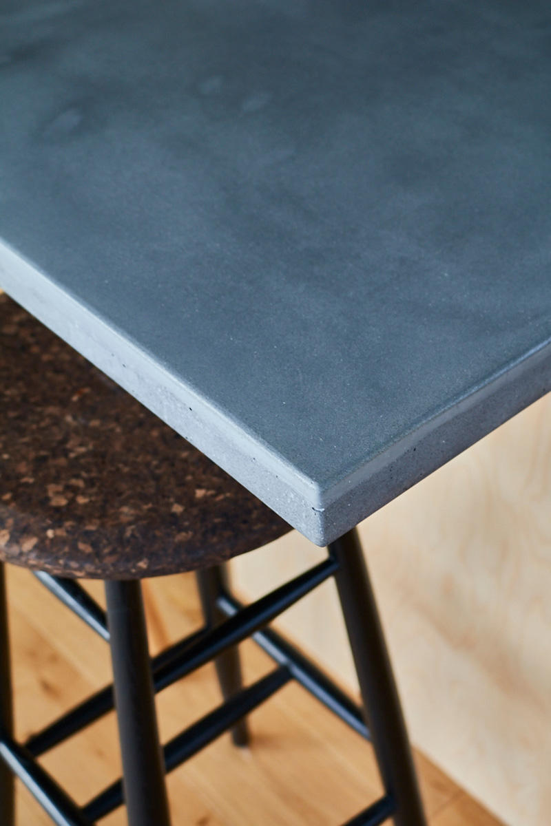 Island worktop corner made from solid grey concrete