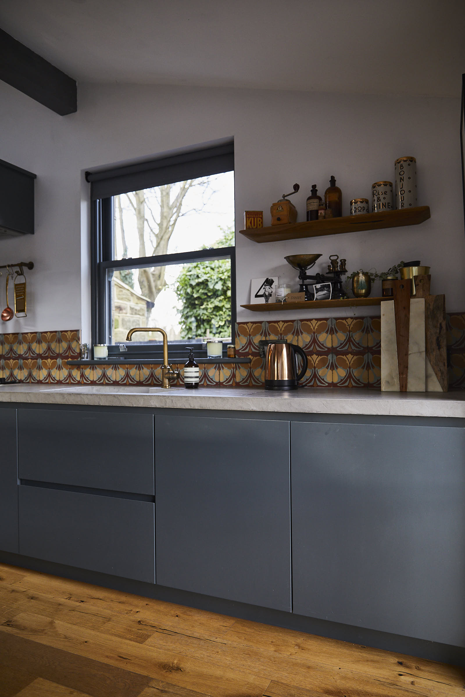 Painted bespoke kitchen units with integrated sink and solid concrete worktops