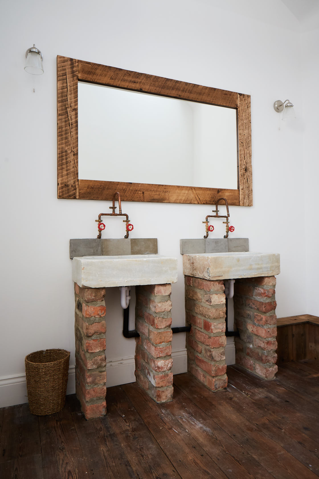 Concrete sinks on bricks with copper pipe taps