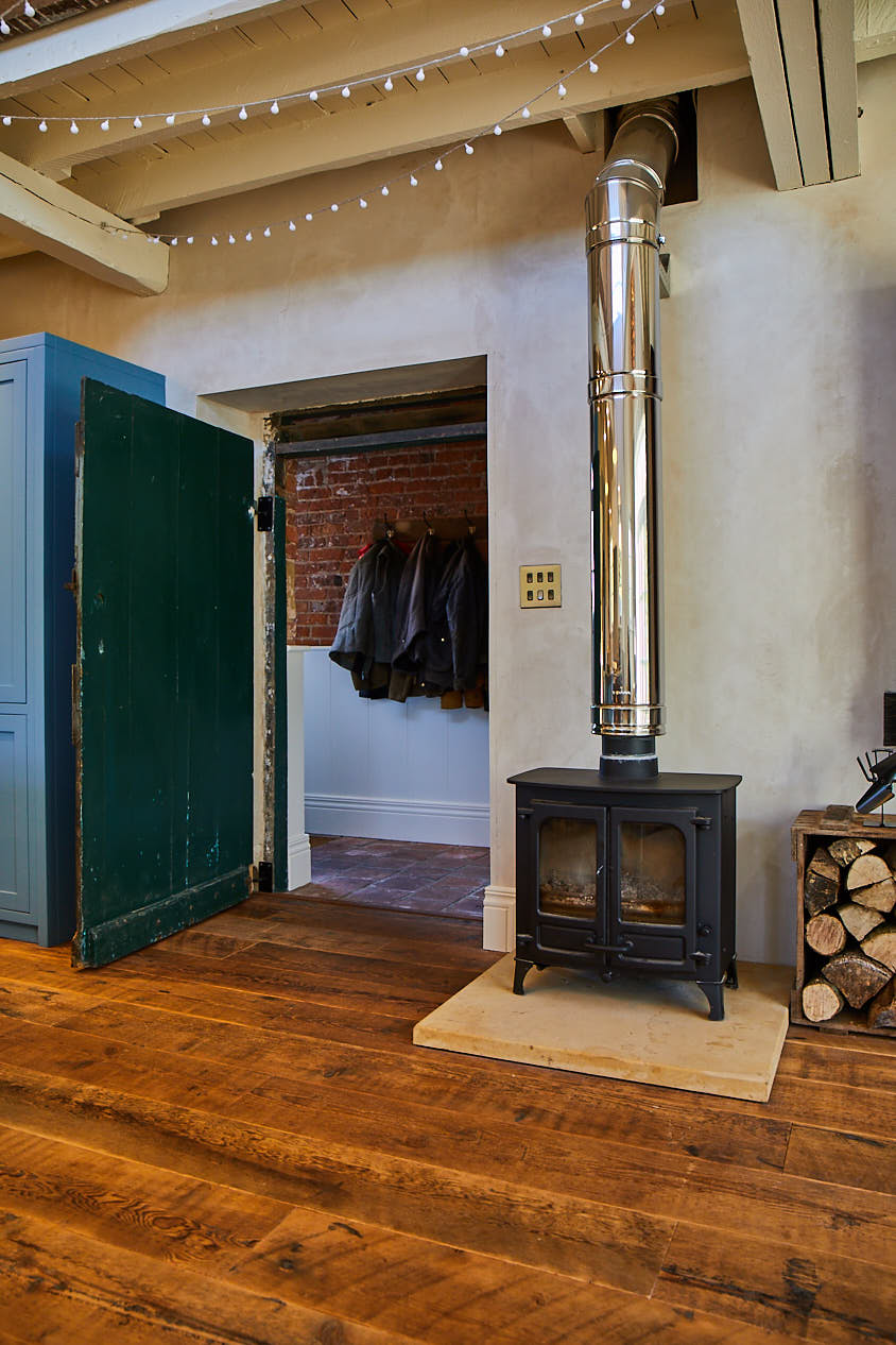 Original fireplace with reclaimed engineered floorboards