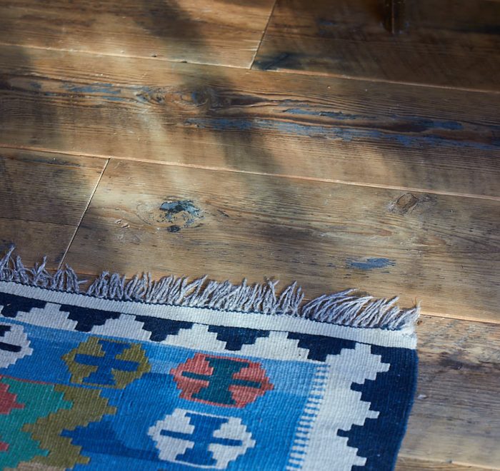 Reclaimed floor boards with Kashgai rug
