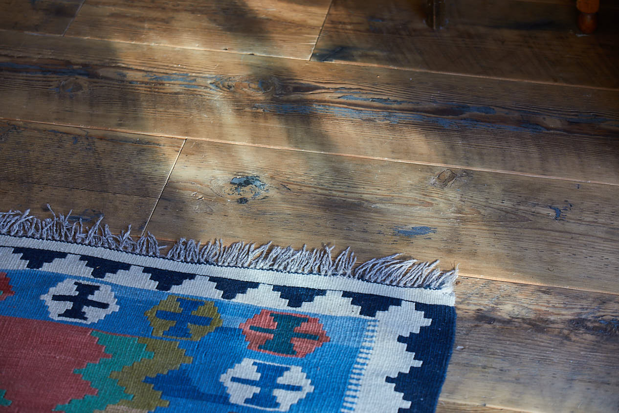 Reclaimed floor boards with Kashgai rug