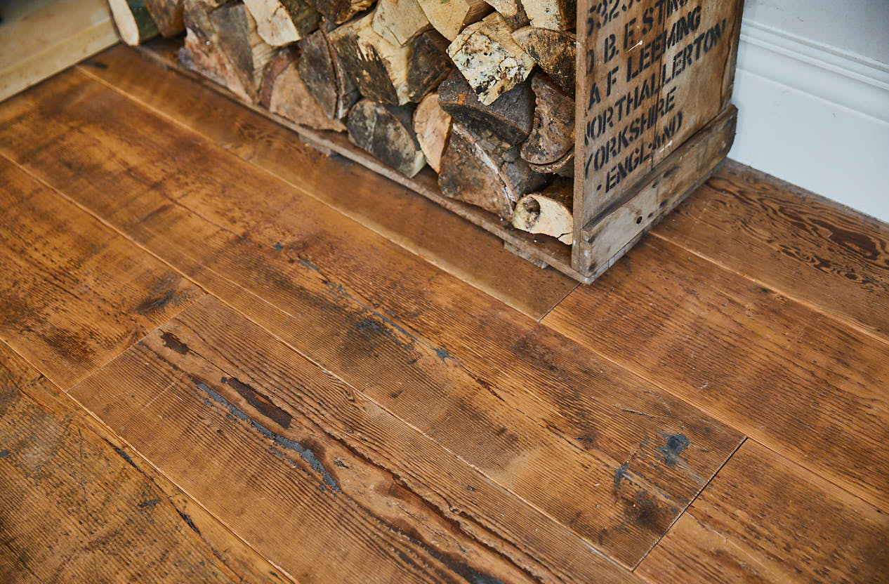 Log basket on reclaimed pine floor boards