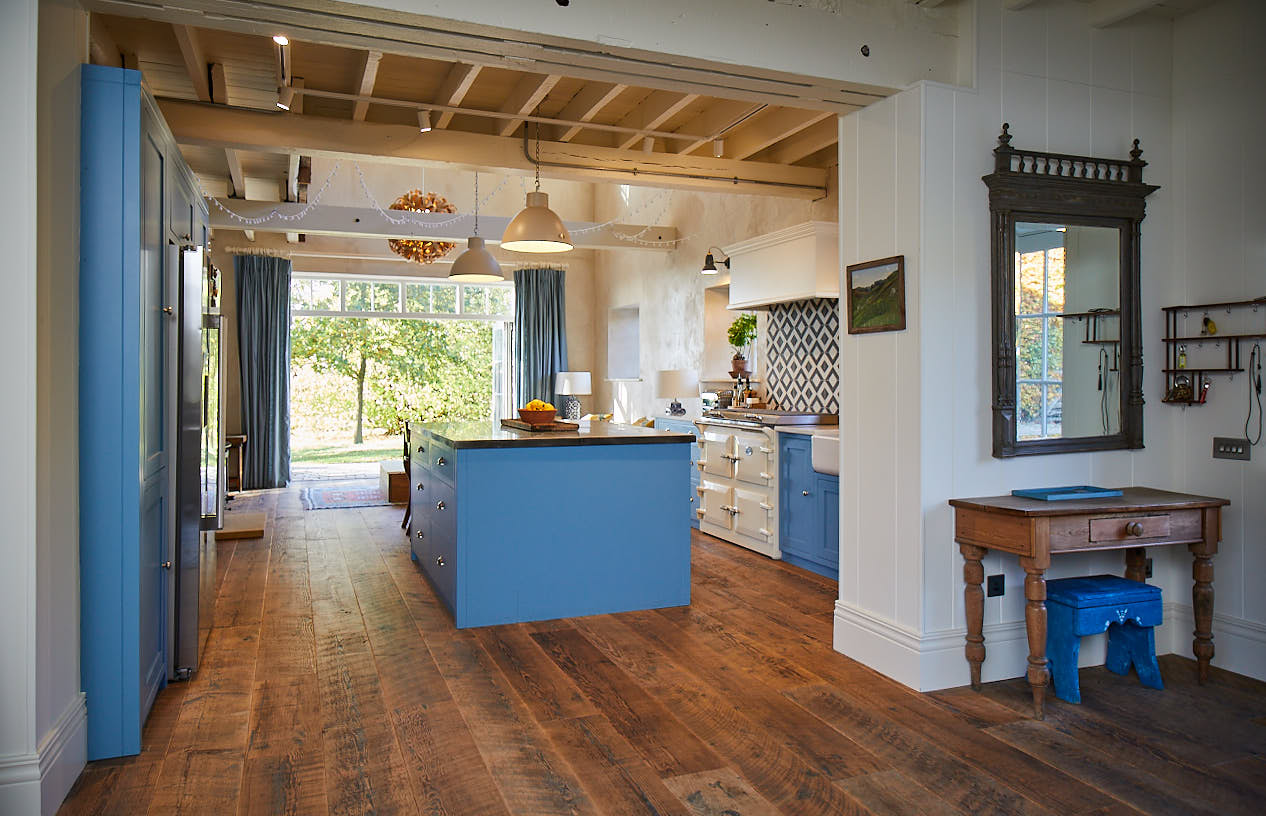 Light blue kitchen with pine flooring