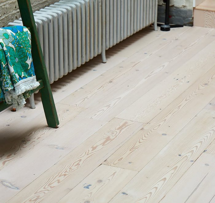 Whitewash pine flooring with green painted ladder