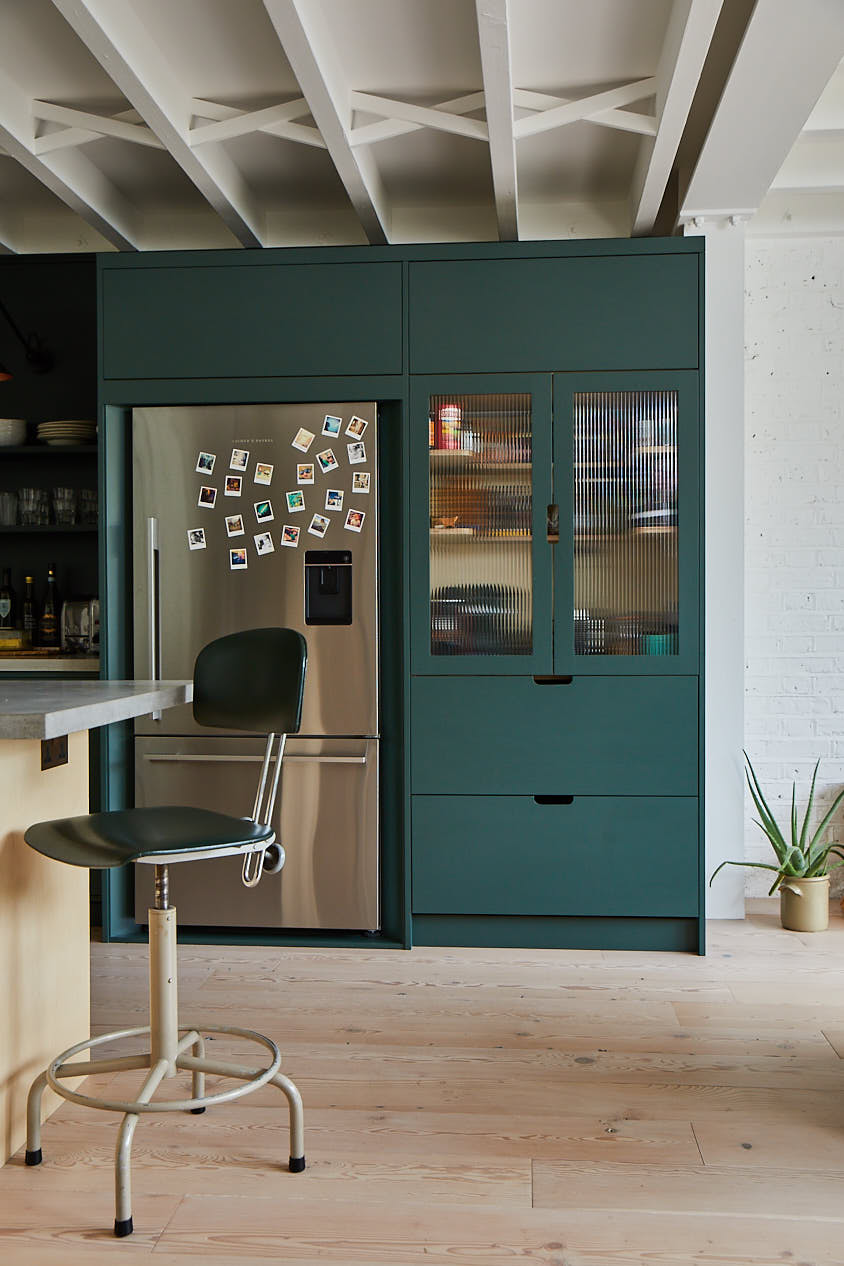 Green glass pantry with stainless steel fridge freezer