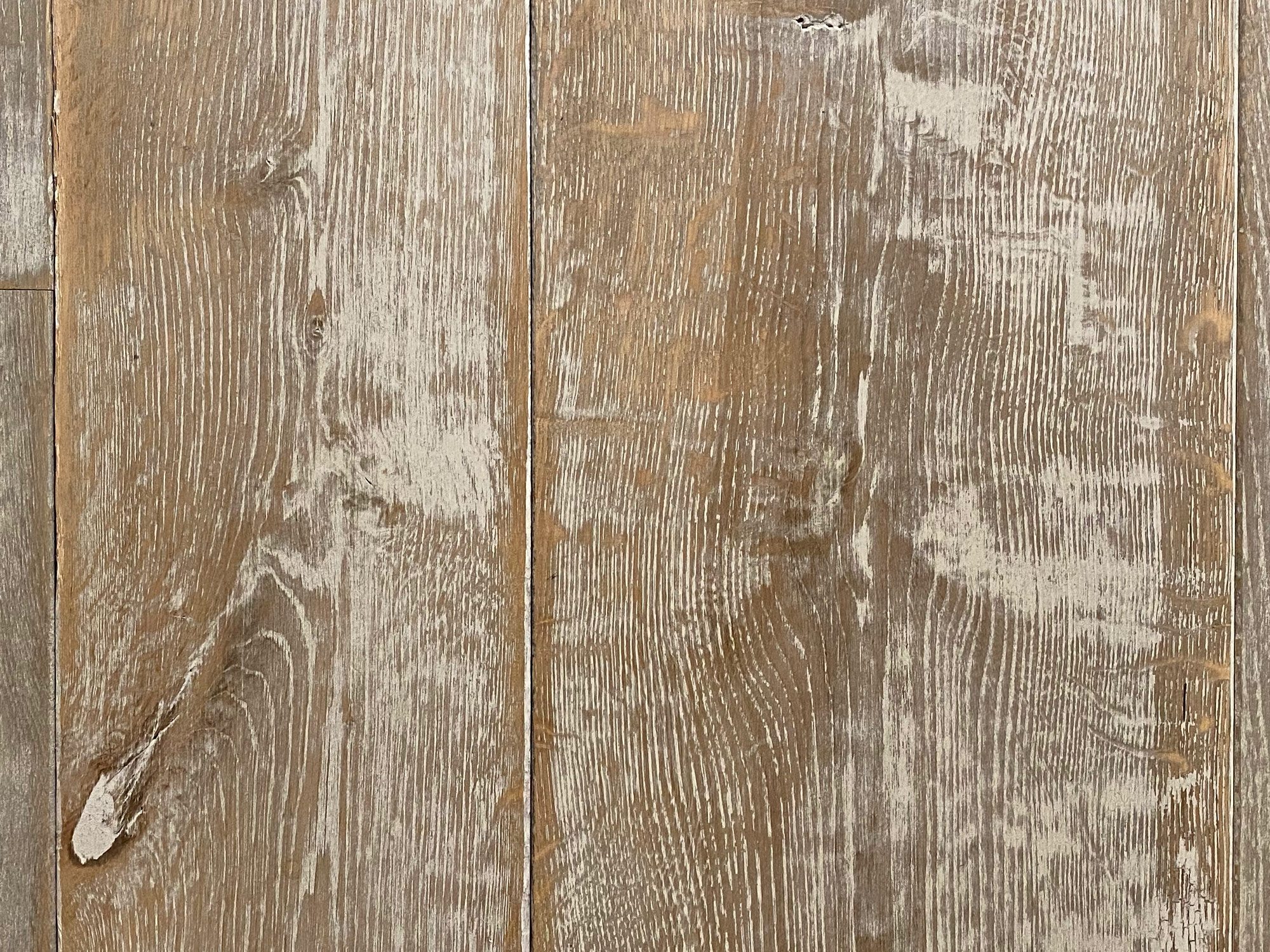 Distressed white paint on engineered oak floor boards