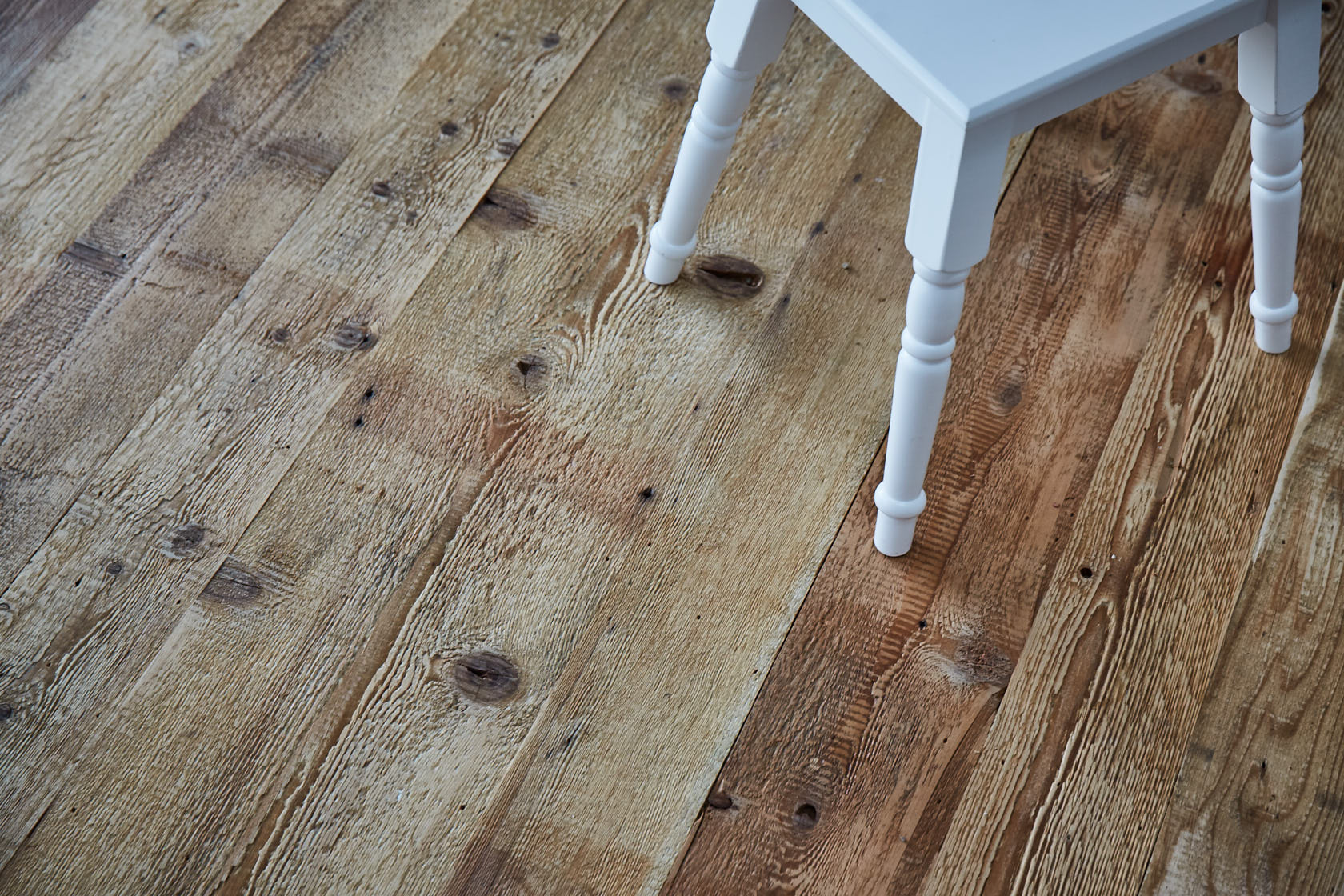 Industrial mill board flooring with white painted stool