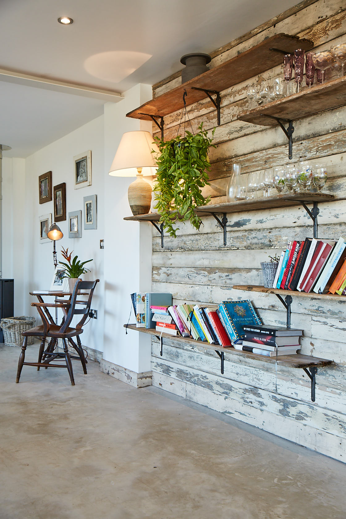 Open book shelves filled with books and plants