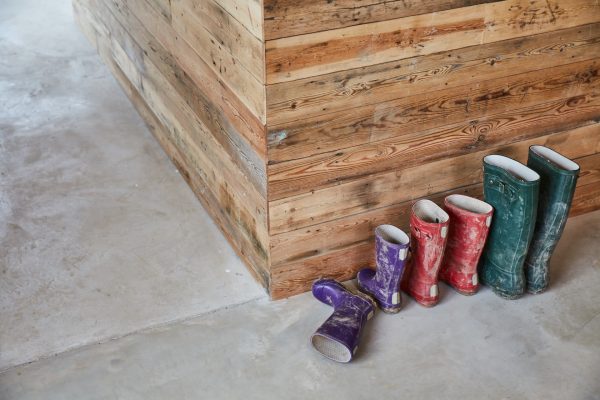 Colourful wellingtons sat on concrete floor