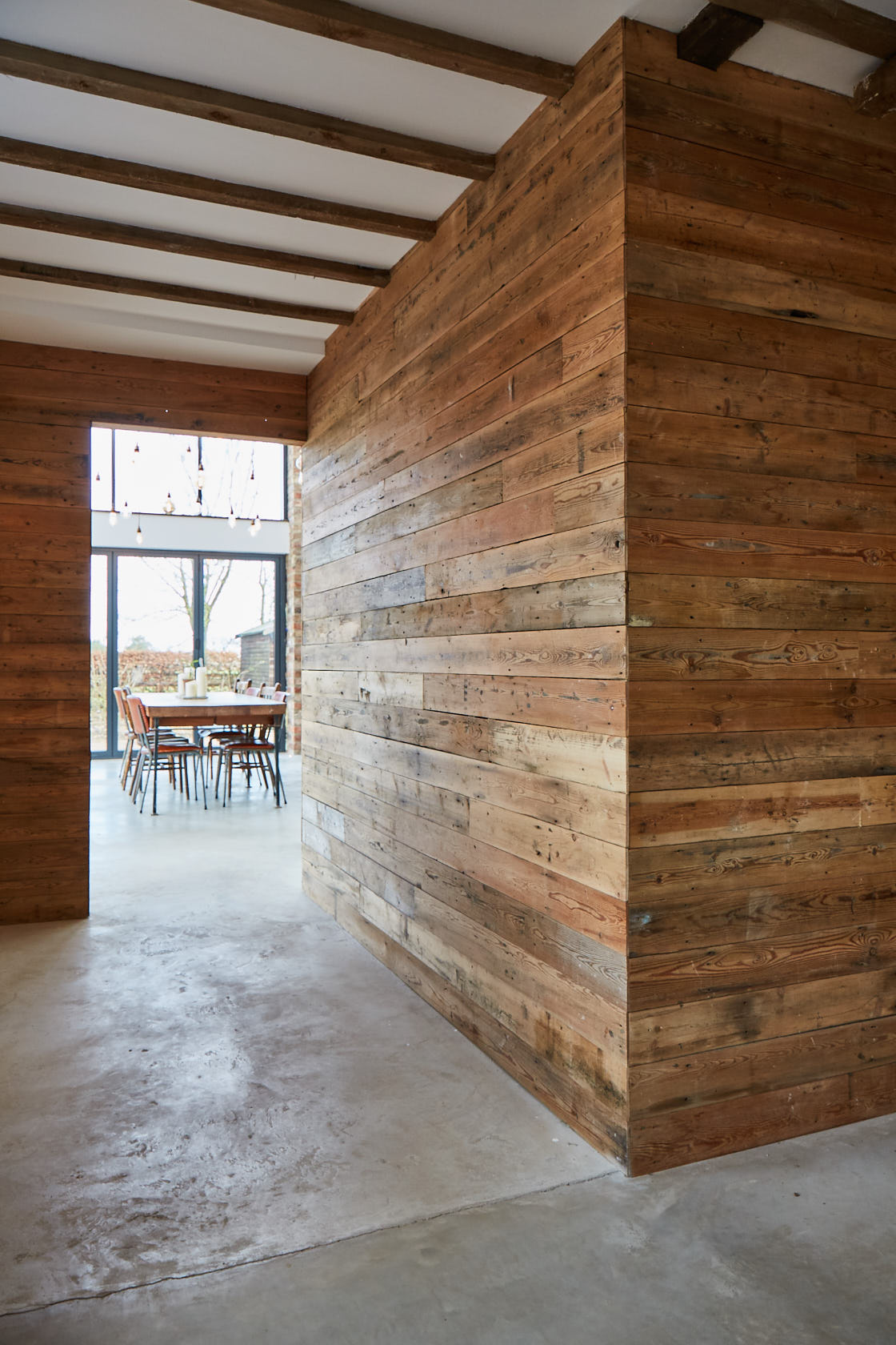 Large wall cladded in reclaimed pine timber