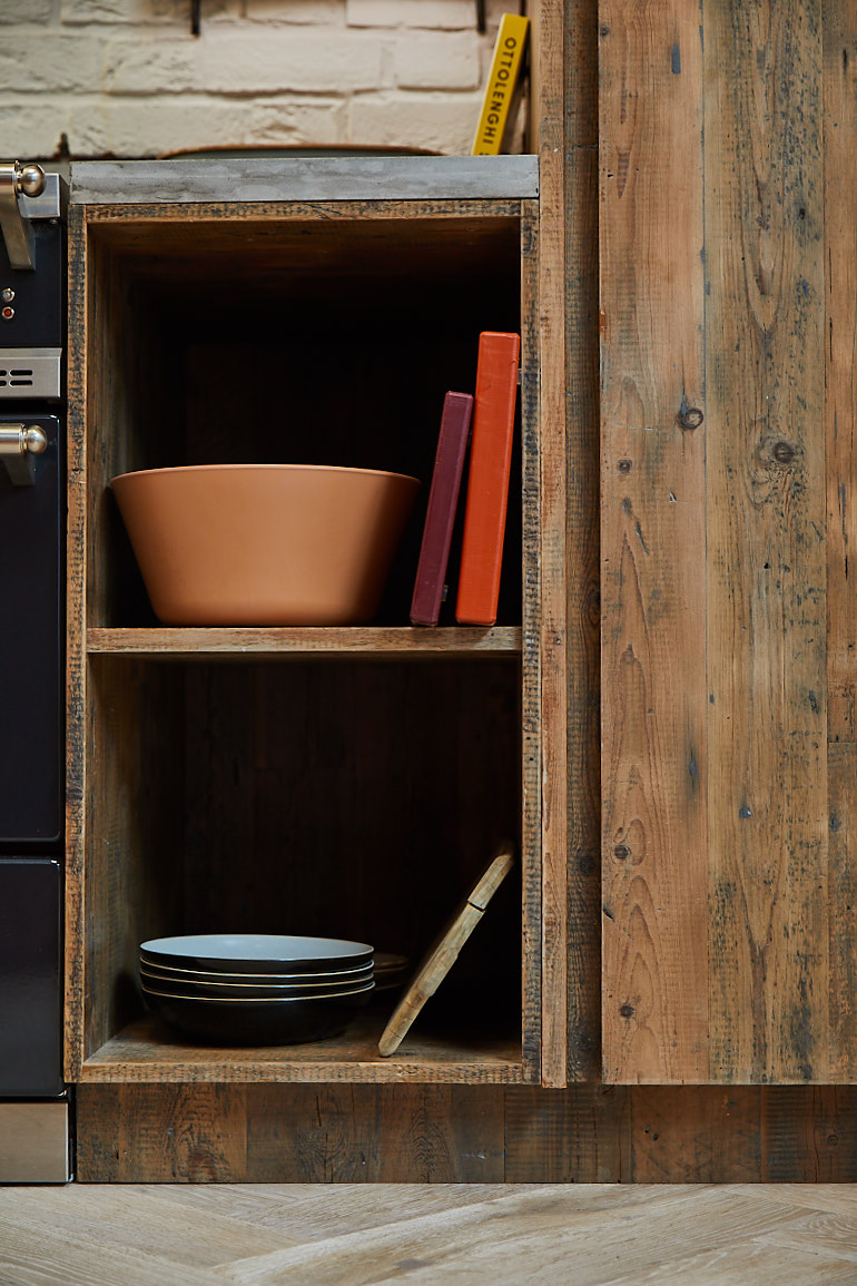 Open shelving unit with bowls and chopping boards